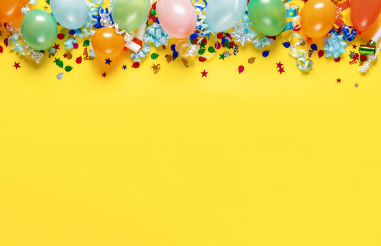 Decoration party on colorful yellow background with copy space top view
