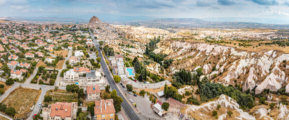 The stunning aerial view of Cappadocia's Pigeon Valley and the impressive Uchisar Castle make a beautiful image that will take your breath away.