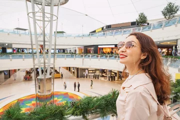 Foto op Canvas Happy stylish asian girl shopping in mall interior © EdNurg