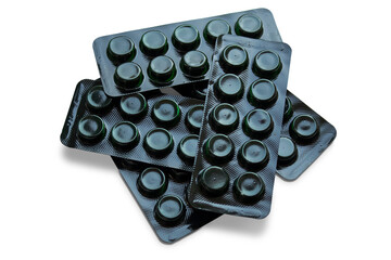 Pile of black activated charcoal blister packs on a transparent background. The concept of treatment, medicine.
