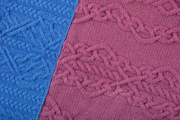 Knitted blue and lilac background. Large knitted fabric with a pattern. Close-up of a knitted blanket.