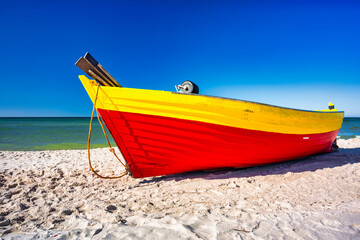 Fishing boat on the sunny Baltic Sea beach in Debki. Poland