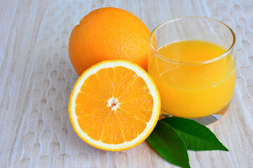 A glass of orange juice with half of orange fruit isolated, close-up  