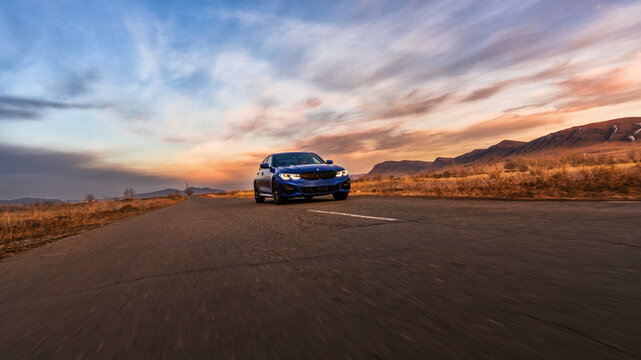 Seattle, Washington, USA March 31, 2023 blue BMW 320 with M3 Performance package. the car is on the road. Sports car concept