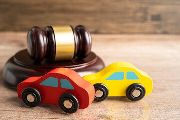 Hammer gavel judge with car vehicle accident, insurance coverage claim lawsuit court case.