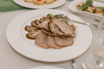meat cut on a plate on a festive table in a restaurant