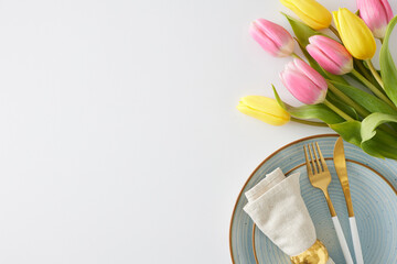 Mother's Day concept. Top view photo of circle plate with cutlery knife fork and napkin with gold ring and bouquet of flowers yellow pink tulips on isolated white background with copy space