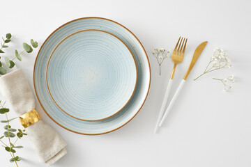 Table setting concept. Top view photo of empty plate cutlery knife fork fabric napkin with gold ring and eucalyptus leaves with gypsophila flowers on white background - Powered by Adobe