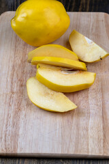 Naklejka na ściany i meble Sliced ripe yellow quince on a cutting board