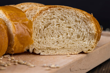 Wheat baguette on a wooden cutting board