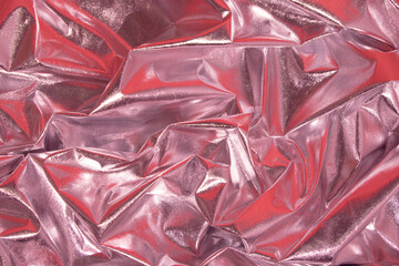 Abstract pink crumpled foil background. Minimal party concept.