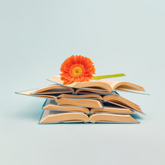 Aesthetic composition of books with colorful flowers on a pastel blue background. Spring or summer...