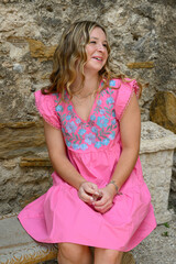 Young pretty teenage girl posing in a historic setting for her high school graduation photos