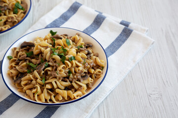 Homemade One Skillet Ground Beef Stroganoff with Mushrooms and Noodles on a Plate, side view. Copy space.