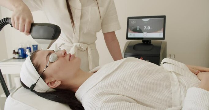 Facial rejuvenation, aesthetic medicine is performing procedure. Woman getting LPG hardware massage at the beauty clinic. Microneedle mesotherapy rejuvenation with laser technology. Beauty treatment.