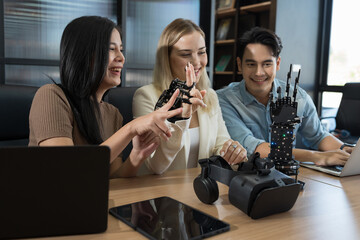 Young male and female working with AI robot arm system project in workshop. Male engineer using...