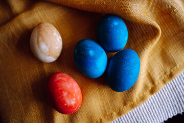 Group of different colorful dyed easter on golden textured bsckground