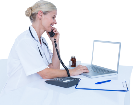 Smiling doctor using laptop while talking on telephone
