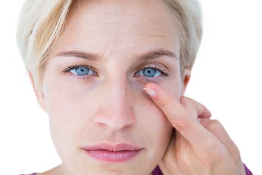 Pretty blonde applying contact lens