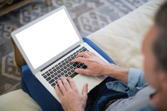 Man using laptop in living room