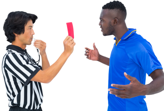 Referee blowing whistle and showing red card to a player
