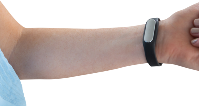 Cropped hand of woman wearing fitness tracker - Powered by Adobe