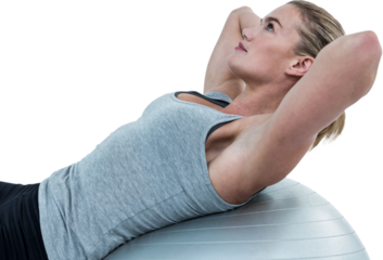 Muscular woman doing sit ups on exercise ball