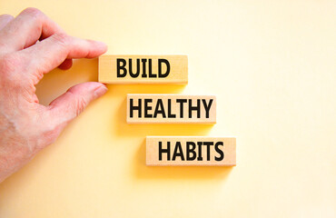 Motivation and Build healthy habits symbol. Concept words Build healthy habits on wooden block on a beautiful white table white background. Business build healthy habits concept. Copy space.