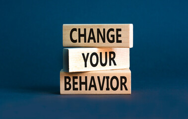 Motivation and Change your behavior symbol. Concept words Change your behavior on wooden block on a beautiful grey table grey background. Business change your behavior concept. Copy space.