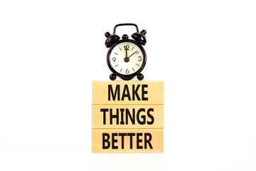 Make things better symbol. Concept words Make things better on wooden block on a beautiful white table white background. Black alarm clock. Business and make things better concept. Copy space.