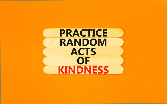 Practice random kind of kindness symbol. Concept words Practice random kind of kindness on wooden stick. Beautiful orange table orange background. Business practice kindness concept. Copy space.