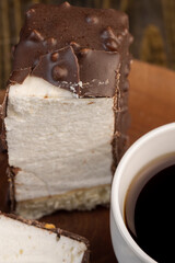 Fresh sweet cake with milk taste and aroma in chocolate glaze