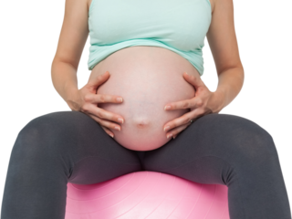 Pregnant woman sitting on pink exercise ball holding her bump