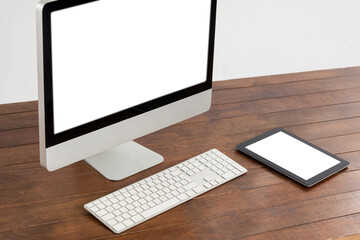 Office desk with computer and digital tablet on desk