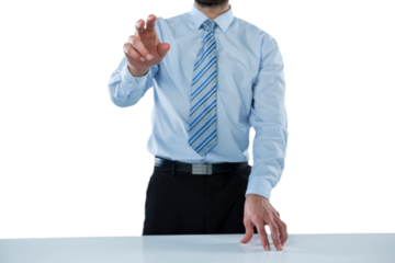 Midsection of businessman touching invisible screen at desk