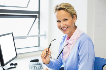 Happy businesswoman while holding eyeglasses