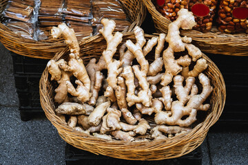 Top view of a wicker basket full of ginger root at a street market.