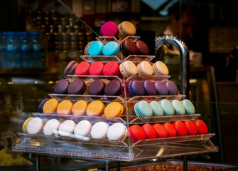 Close-up of a pyramid of macaroons in the window of a pastry shop. Blurred background.