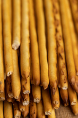 Thin and long bread sticks made of wheat flour on the table