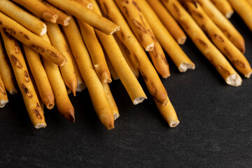 Thin and long bread sticks made of wheat flour on the table