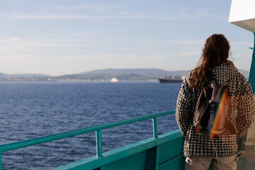 Fototapeta premium Man looking at the sea from the deck of a ferry