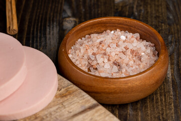 Pink natural salt on the table, close up
