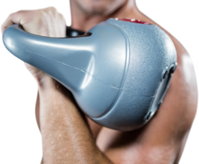 Close-up of shirtless sportsman working out with kettlebell