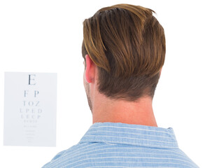 Focused man in suit on eye test letters