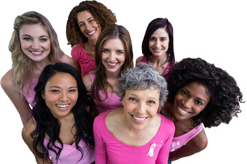 Smiling women in pink outfits posing for breast cancer awareness
