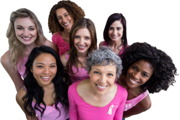 Smiling women in pink outfits posing for breast cancer awareness