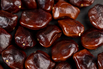 brown tamarind seeds on the table, scattered seeds