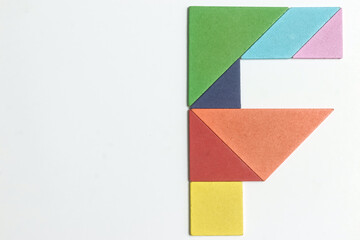 Color tangram puzzle in english alphabet F shape on white background