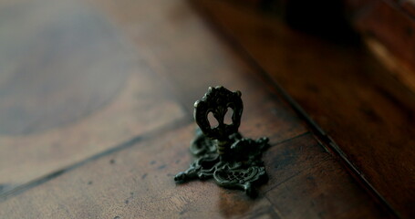 Hand inserting key in antique furniture