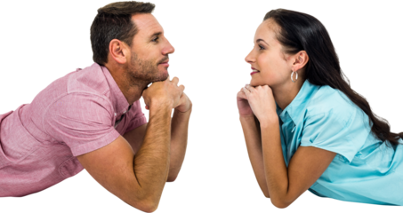 Happy couple laying on floor looking at each other